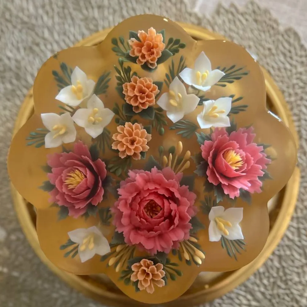 Golden scalloped jelly cake with peonies and lilies