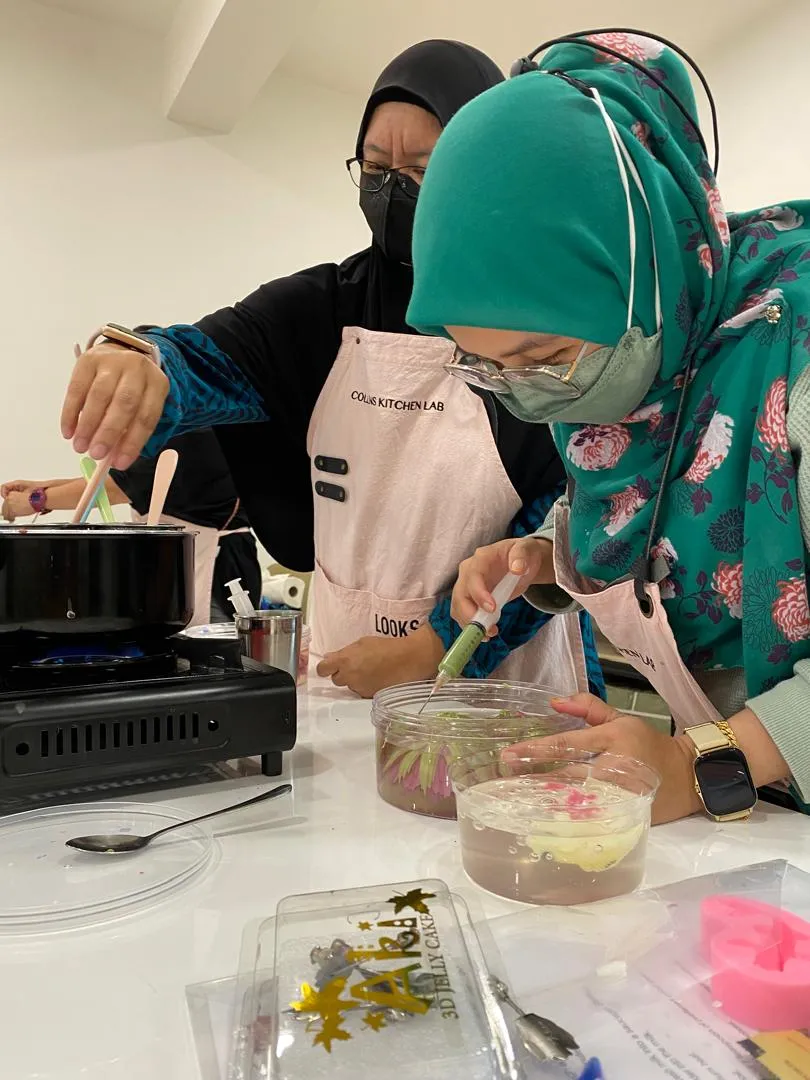 A student injecting coloured jelly to form petals