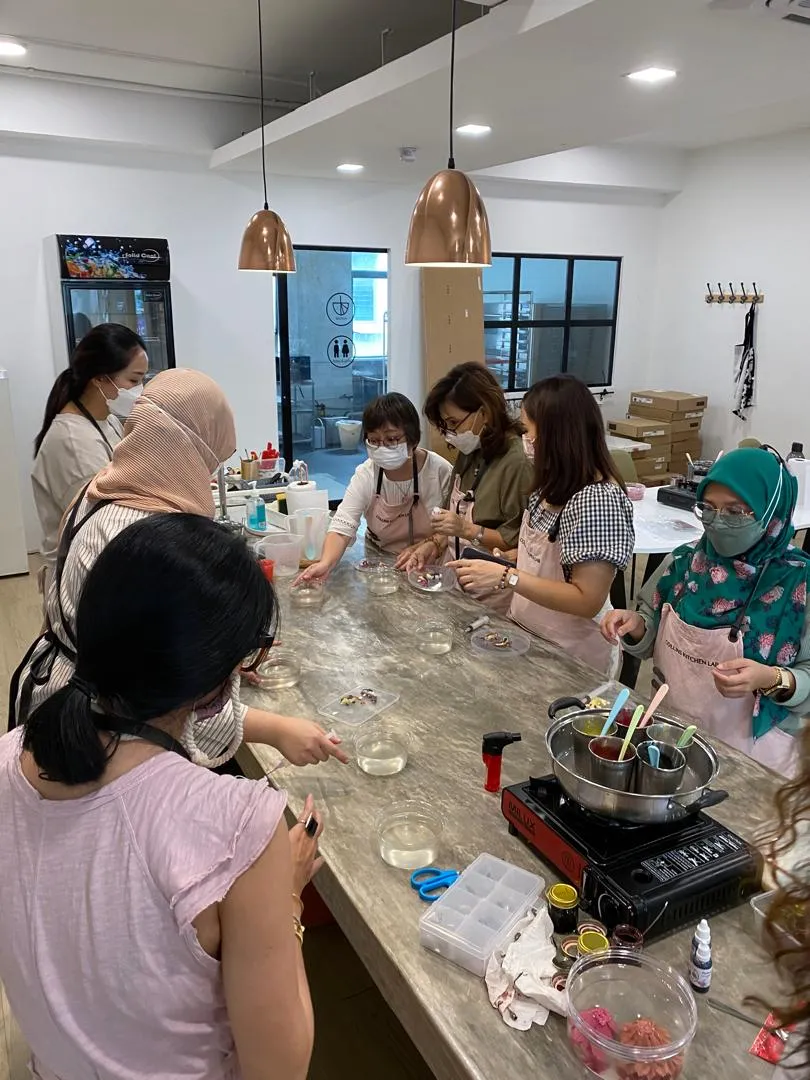 Students carving jelly flowers around the counter